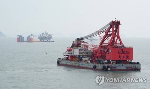 3月22日，在全罗南道珍岛海域，上海打捞局进行“世越”号客轮打捞试验。（韩联社/海洋水产部提供）