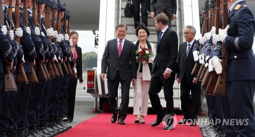 当地时间7月5日上午，韩国总统文在寅（左）及夫人金正淑女士抵达柏林，展开为期6天的访德行程。（韩联社）