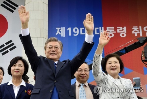 5月10日，在首尔国会，韩国第19任总统文在寅和夫人金正淑女士在就职仪式结束后向民众挥手致意。（韩联社）