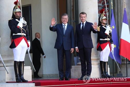 当地时间10月15日，在法国巴黎，韩国总统文在寅（左）和法国总统马克龙在举行会晤前合影。（韩联社）