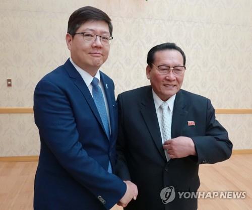 资料图片：韩方民和协常任议长金弘杰（左）和朝方民和协议长金永大（韩联社） 