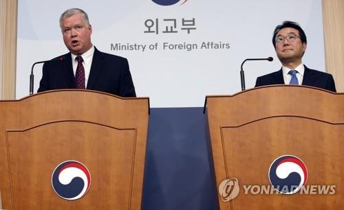 12月16日，在首尔韩国外交部大楼，比根（左）和李度勋共同会见记者。 韩联社