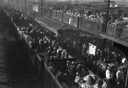 该照片拍摄于1950年12月的大邱，每一节火车车厢里都挤满了难民。可以看出其中有人背着毯子和衣服御寒。 韩联社/ICRC供图（图片严禁转载复制）