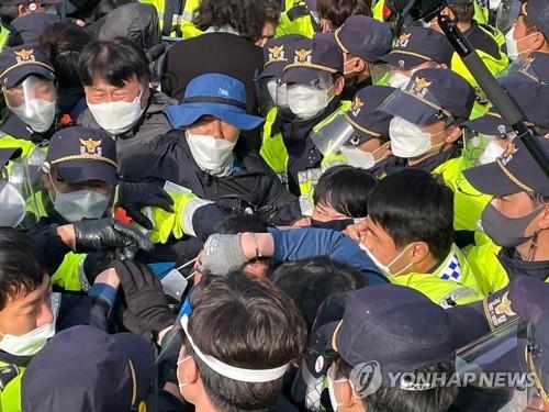 资料图片：4月28日上午，在位于庆尚北道星州郡的“萨德”反导基地入口，警方驱离示威人员。 韩联社