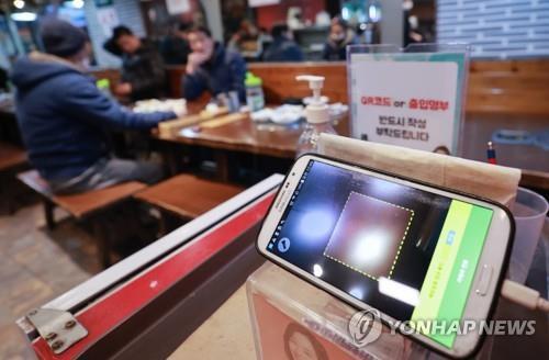 资料图片：首尔一家餐厅入口处放着扫码终端，图片摄于1月13日。 韩联社