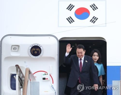 7月1日，在位于京畿道城南市的首尔机场，韩国总统尹锡悦（左）和夫人金建希准备下机。 韩联社