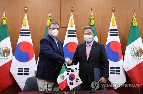 7月4日，在首尔外交部大楼，韩国外交部长官朴振（右）会见到访的墨西哥外交部长马塞洛·埃布拉德。图为两位外长在签署《韩墨关于发展合作的谅解备忘录》后握手合影。 韩联社