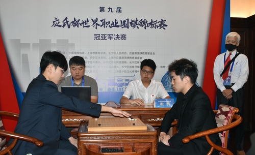 8月21日，在上海市，第九届“应氏杯”世界职业围棋锦标赛三番棋决赛首局比赛战罢，韩国棋手申真执黑谞（左）253手中盘战胜中国谢科。 韩联社/韩国棋院供图（图片严禁转载复制）