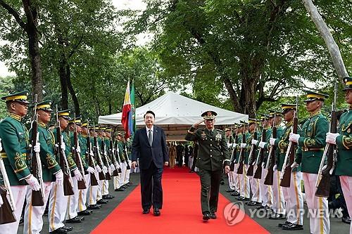 当地时间10月6日，在菲律宾马尼拉国家英雄墓地，韩国总统尹锡悦（左）到访并检阅仪仗队。 韩联社/联合采访团