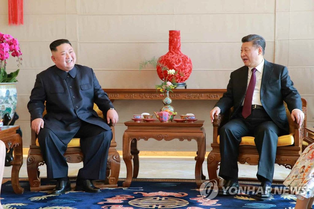 资料图片：朝鲜党报《劳动新闻》1月10日刊登朝鲜国务委员会委员长金正恩（左）9日在北京饭店与中国国家主席习近平喝茶交谈的照片。图片仅限韩国国内使用，严禁转载复制。（韩联社/《劳动新闻》）