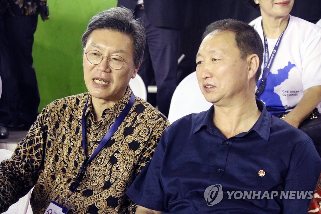 资料图片：2019年6月25日，“亚洲和平杯”国际排球赛在印尼雅加达举行。图为时任韩国驻印尼大使金昌范（左）和朝鲜驻印尼大使安光日观看赛事。 韩联社