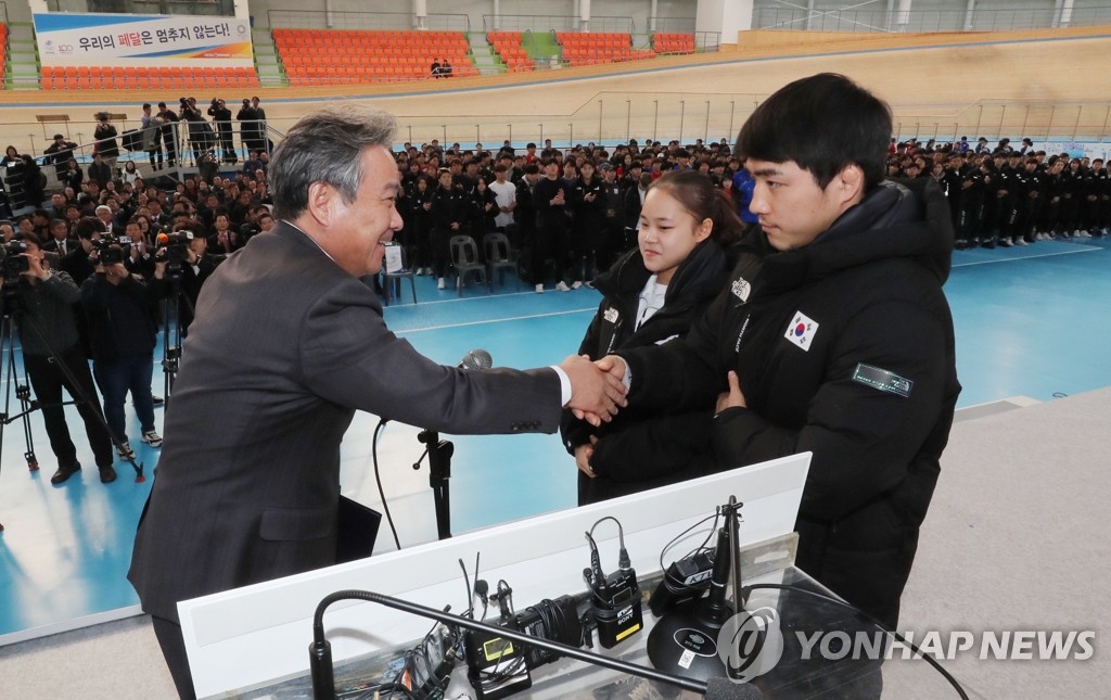 仪式在镇川运动员村举行,大韩体育会会长李起兴(左)与运动员代表握手