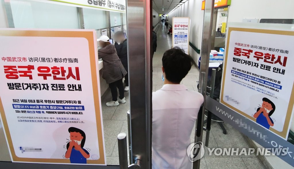 资料图片：1月21日，位于京畿道水原市的一家医院入口贴着有关“武汉肺炎”疫情的提醒指南。 韩联社