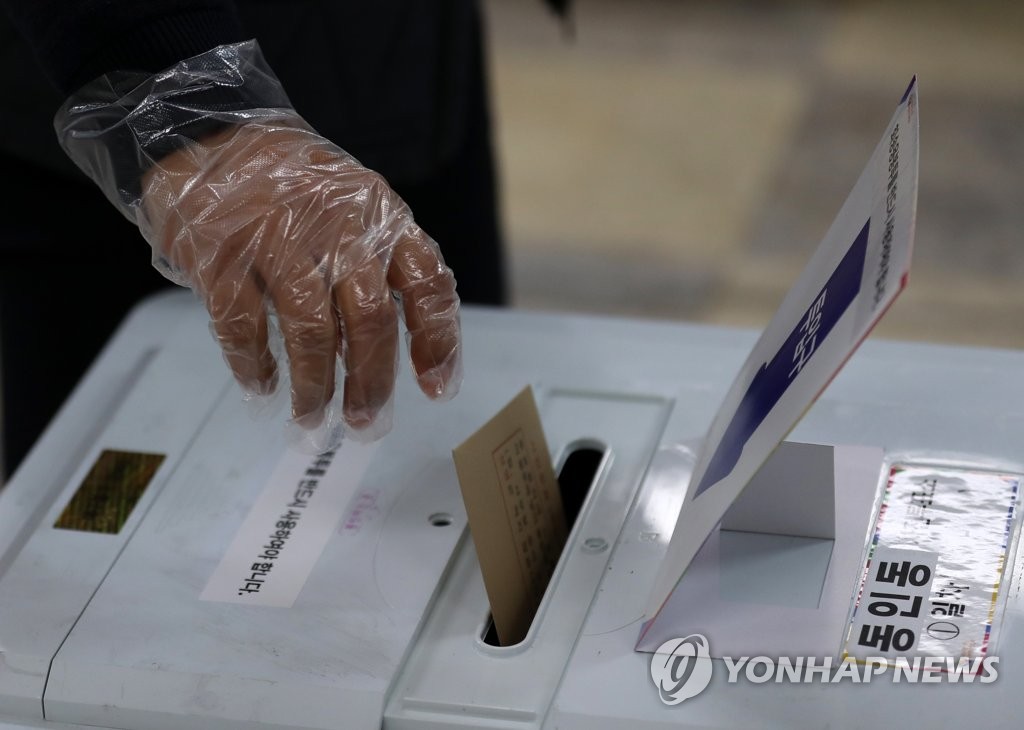 资料图片：戴一次性手套投票 韩联社