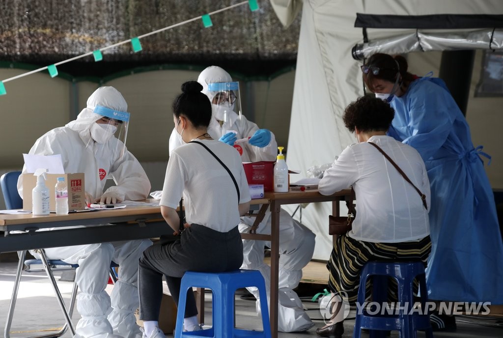 资料图片:医务人员在筛查诊所进行病毒检测。 韩联社