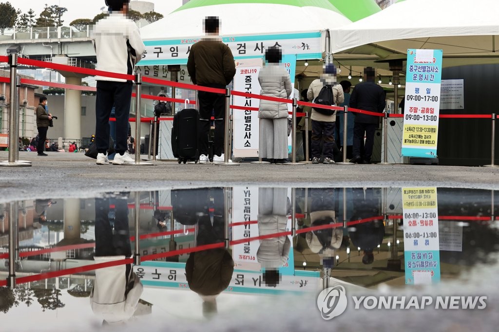 资料图片：市民们排队待检。 韩联社