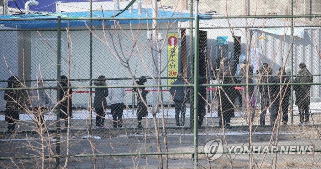 资料图片：2月17日上午，在设于顺天乡大学首尔附属医院的临时筛查诊所，市民们排队等候接受病毒检测。 韩联社