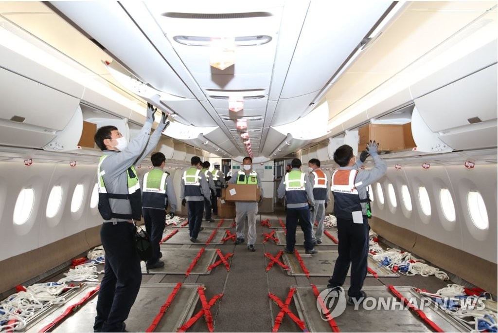 资料图片：2月22日，在一架A350机里，韩亚航空员工进行客机改装工作。 韩联社/韩亚航空供图（图片严禁转载复制）