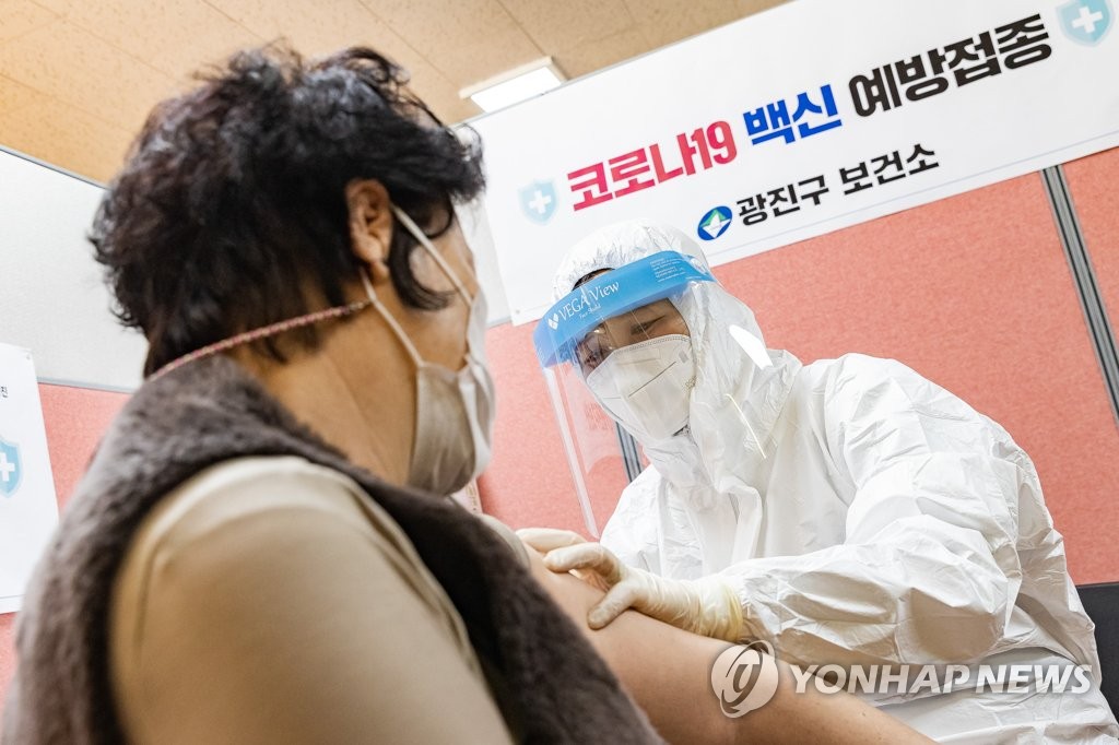 资料图片：2月26日，在首尔市广津区卫生站，医务人员为市民接种阿斯利康新冠疫苗。 韩联社/广津区政府供图（图片严禁转载复制）