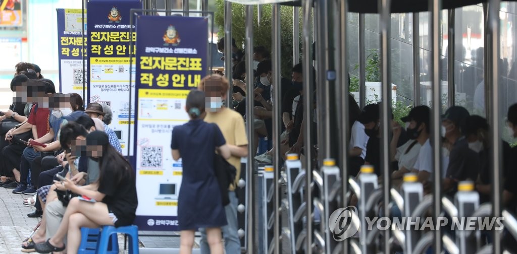 资料图片：排队待检的市民 韩联社