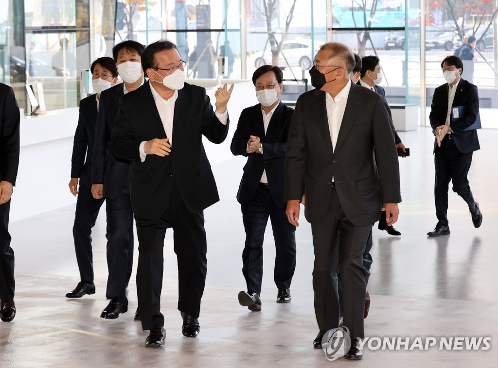 11月22日，在位于京畿道高阳市的“现代汽车工作室高阳”，韩国国务总理金富谦（前排左）和现代汽车集团会长郑义宣（前排右）走向会场。 韩联社