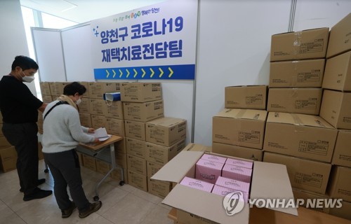 资料图片：政府工作人员清点将向居家治疗新冠患者发放的物品。 韩联社