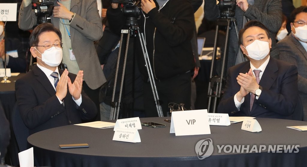 12月27日，共同民主党总统候选人李在明（左）和国民力量总统候选人尹锡悦出席在首尔中区的韩国新闻中心举行的地方自治大奖及韩国地区发展大奖颁奖礼。 韩联社/国会摄影记者团