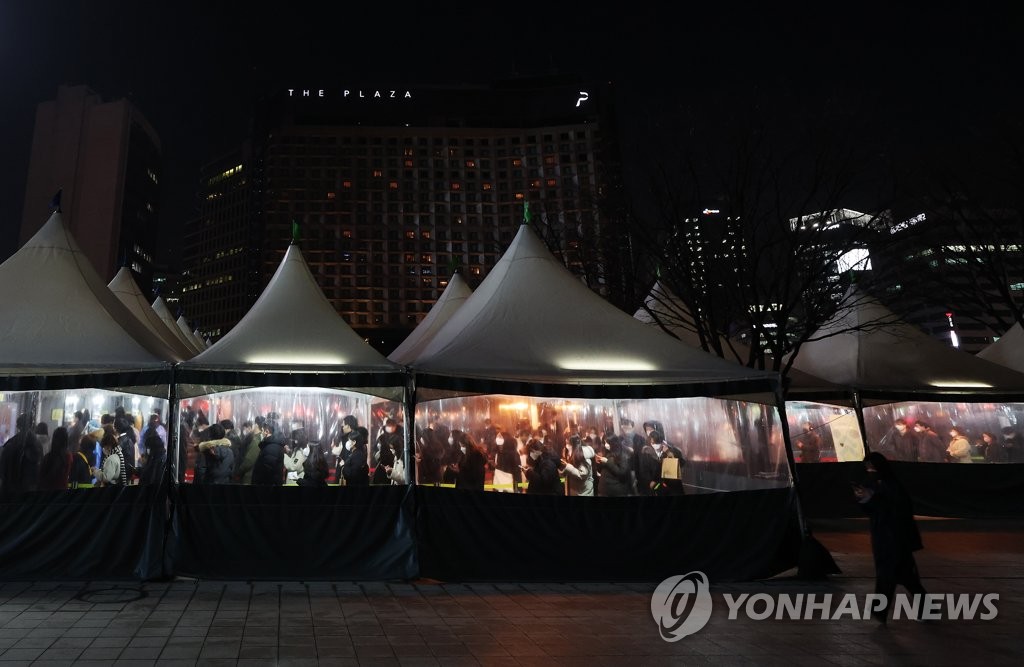 资料图片：1月27日晚，位于首尔广场的新冠筛查诊所灯火通明。 韩联社
