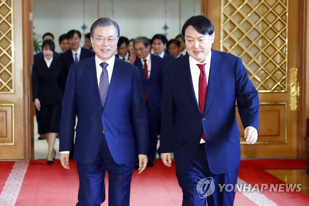 资料图片：2019年7月25日，文在寅任命尹锡悦为检察总长后，一起走向座谈会场。 韩联社