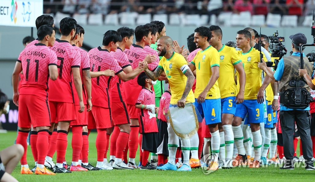 6月2日下午，在首尔世界杯体育场，韩国队即将与巴西队展开一场热身赛。图为两队赛前相互击掌。 韩联社