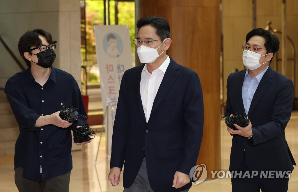6月7日，在首尔市江西区首尔金浦商务航空中心，李在镕（居中）准备登机出境。 韩联社