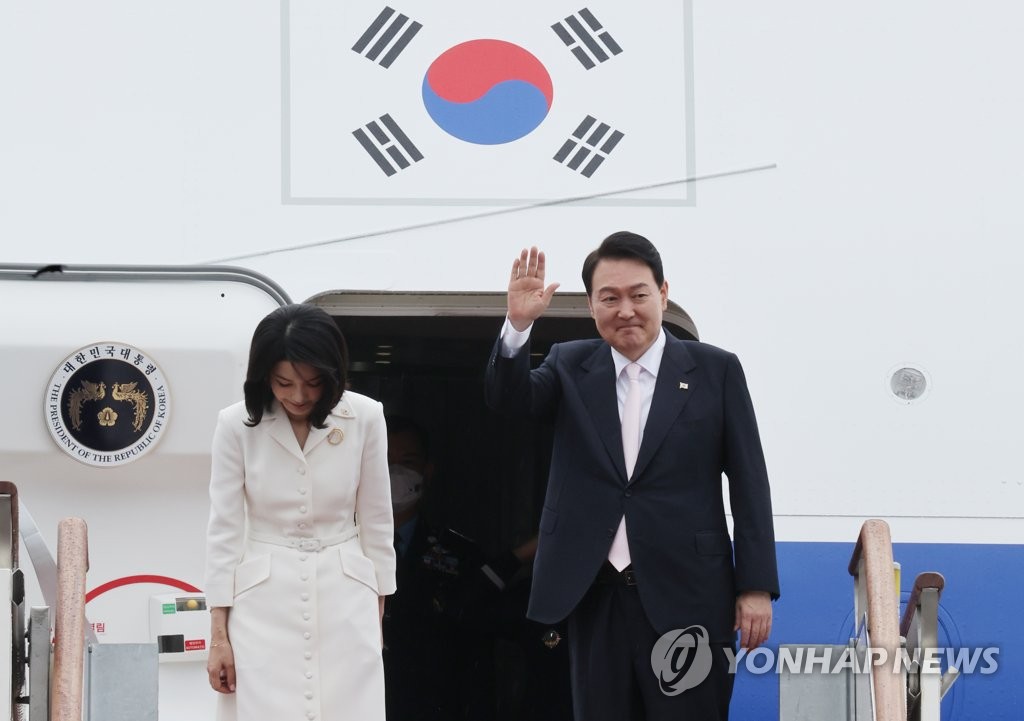 资料图片：6月27日，在位于京畿道城南市的首尔机场，韩国总统尹锡悦（右）和夫人金建希正在踏上总统专机空军一号。 韩联社/总统室通讯摄影记者团