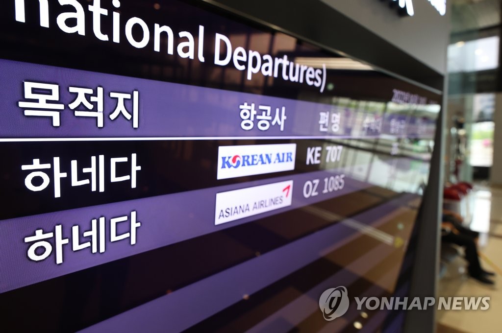 资料图片：机场大屏幕显示飞往羽田机场的航班。 韩联社