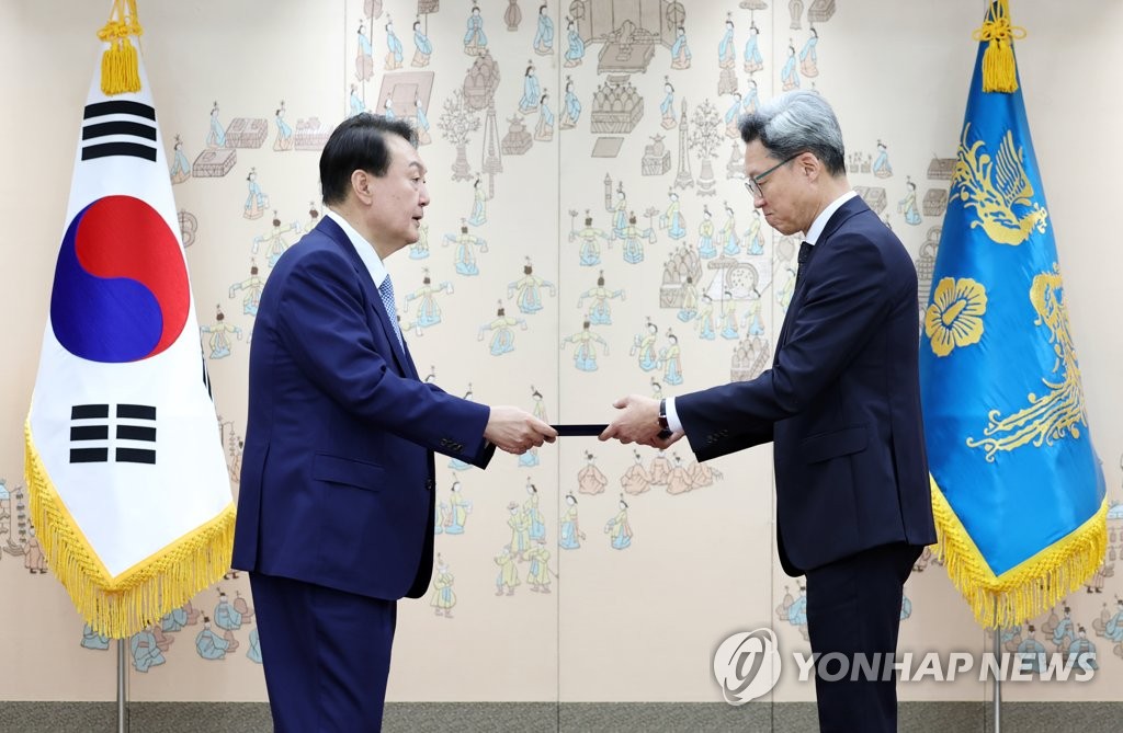 资料图片：7月15日，在首尔市龙山总统府，韩国总统尹锡悦（左）向新任韩国驻华大使郑在浩颁发任命状。 韩联社