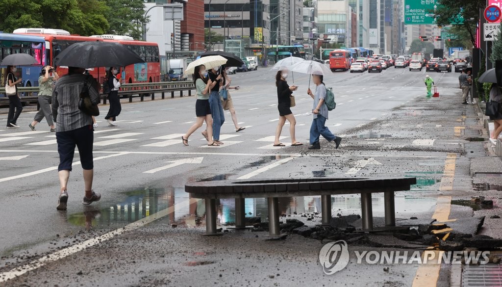 8月9日，首尔市江南区一段道路因暴雨受损。 韩联社