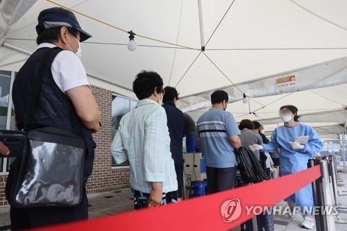 资料图片：市民排队接受病毒检测。 韩联社