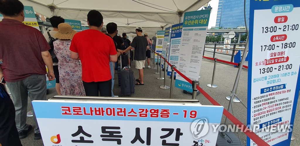 资料图片：8月14日，在设于首尔站的筛查诊所，市民排队等待检测。 韩联社