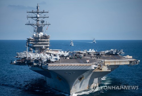 资料图片：9月29日，在韩国东海公海海域，韩美海军舰艇正在进行联演。图为美国“里根”号核动力航母航行。 韩联社/韩国海军供图（图片严禁转载复制）