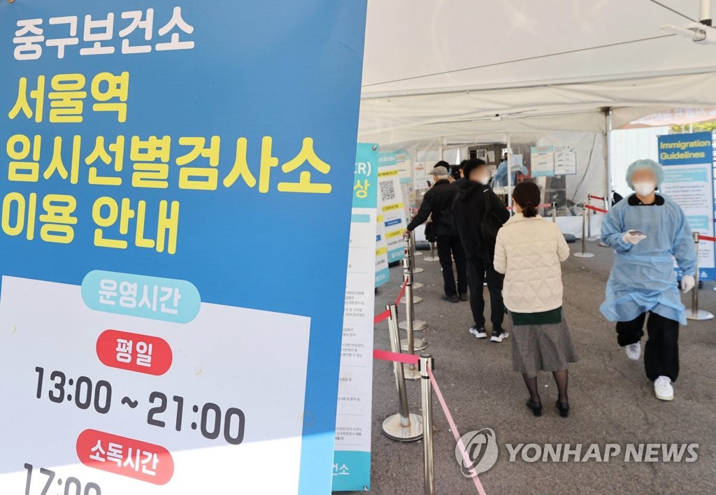 资料图片：10月25日，在首尔站临时筛查诊所，市民排队接受检测。 韩联社