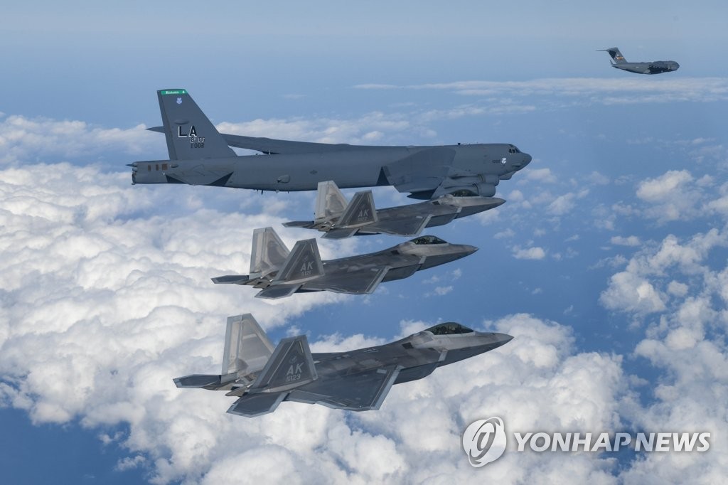 资料图片：12月20日，在韩半岛附近空域，美国空军B-52H“同温层堡垒”战略轰炸机、F-22“猛禽”战斗机、C-17运输机正在编队飞行。 韩联社/韩国国防部供图（图片严禁转载复制）