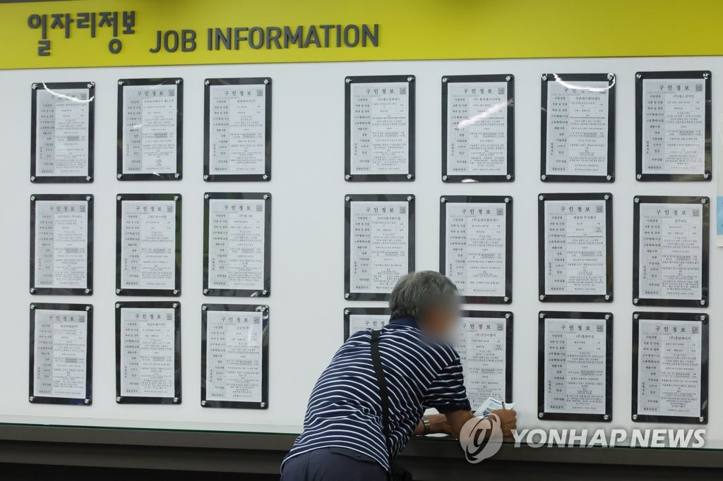 资料图片：求职者查看就业信息。 韩联社