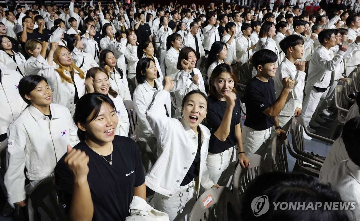 9月12日，在首尔奥林匹克公园，第19届杭州亚运会韩国体育代表团成立大会举行。图为选手们握拳加油。 韩联社