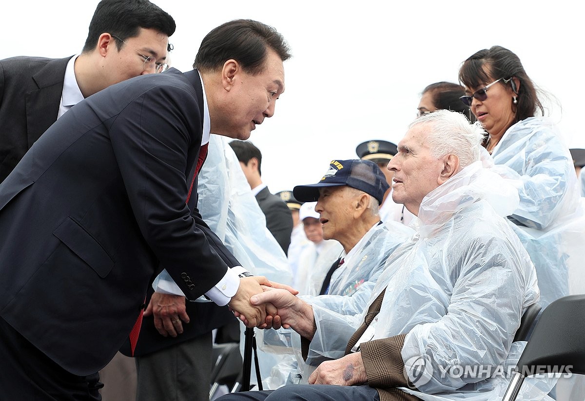 9月15日，在海军登陆舰“露积峰”号上，韩国总统尹锡悦（左）同参战老兵亲切交谈。 韩联社/总统室通讯摄影记者团（图片严禁转载复制）