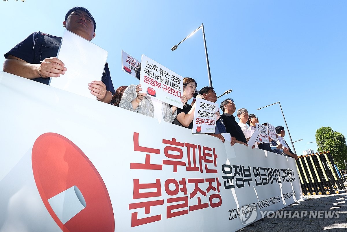 资料图片：8月30日，在首尔龙山总统府附近，一民间团体举行记者会，谴责政府养老金改革案。 韩联社